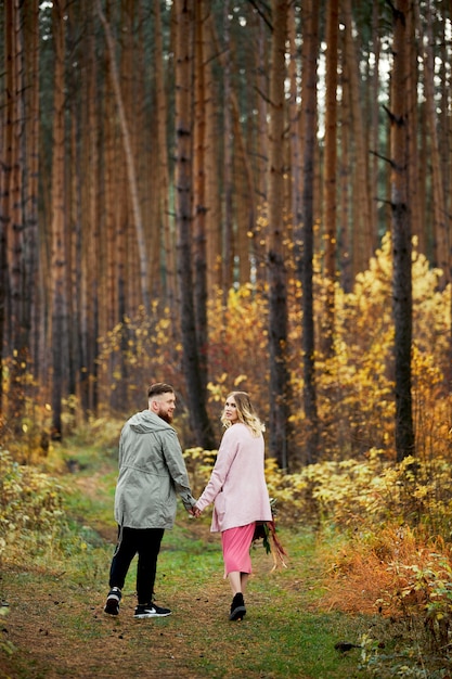 Couple in love walks through autumn forest