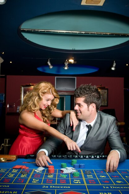 couple in love winning money at the casino tables