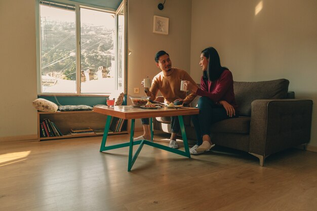 Couple of lover is having breakfast in the house in the morning.