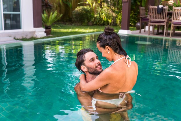 Couple of lovers in a beautiful villa with swimming pool