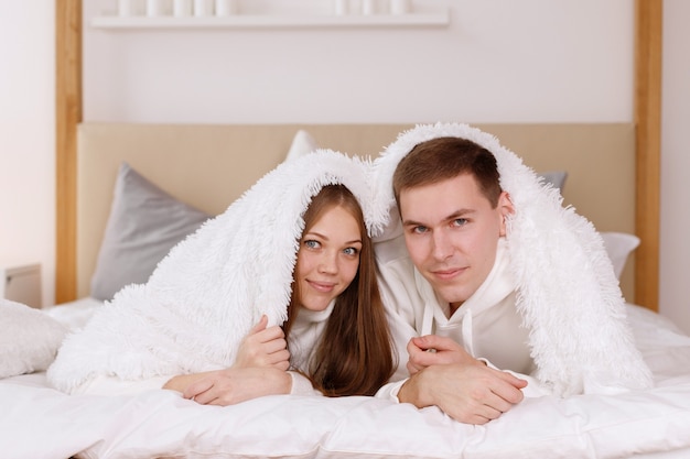 Couple of lovers on a blanket at home at the weekend