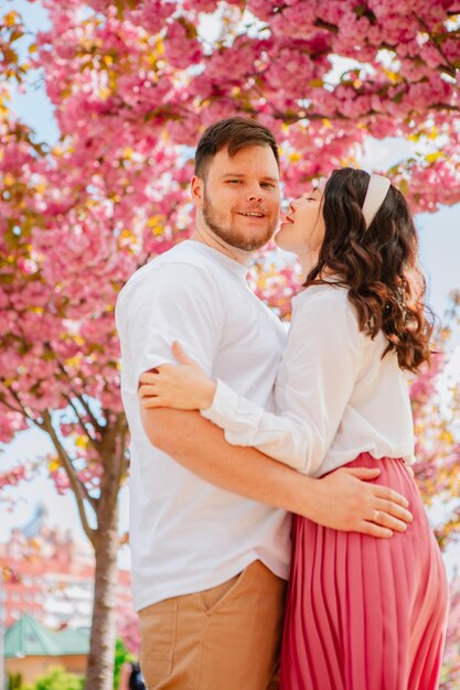 Couple lovers under blooming sakura tree spring season