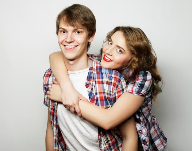 Couple in loveYoung woman and man wearing casual wear over grey background