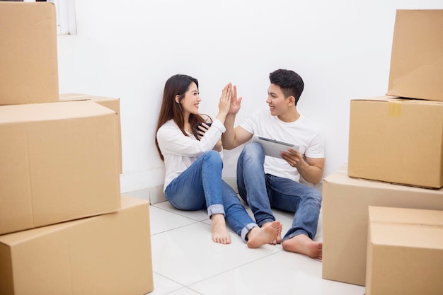 Couple makes high five hand gesture in a new house