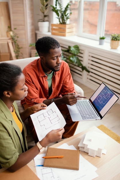 Photo couple making plans together for renovating home