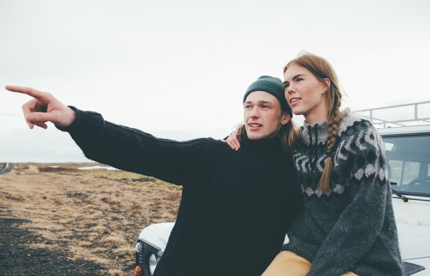 Couple making a wanderlust vacation, exploring iceland with their 4x4 jeep