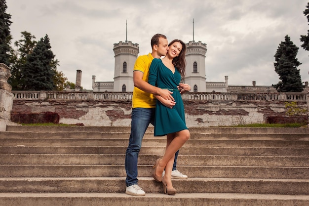 Couple of man and woman posing near old ancient castle