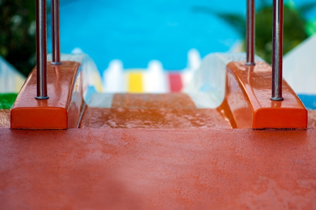 Couple man and woman ride with colorful water slides.