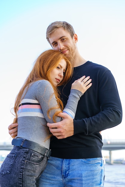 couple of man and woman with long red hair of caucasian ethnicity in casual clothes stand on t