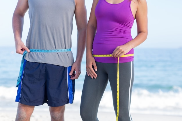 Couple measuring their waist