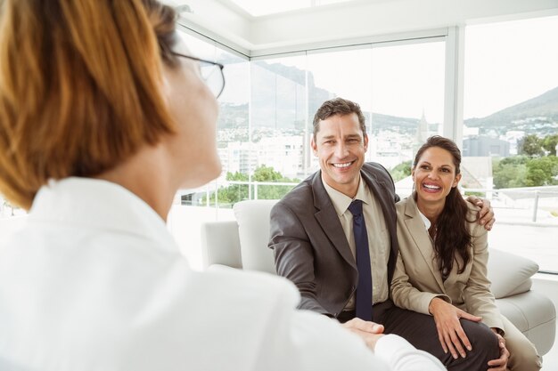 Couple in meeting with financial adviser at home