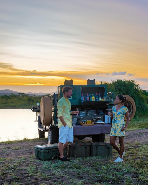 Couple men and asian woman on safari in south africa luxury\
safari car game drive south africa