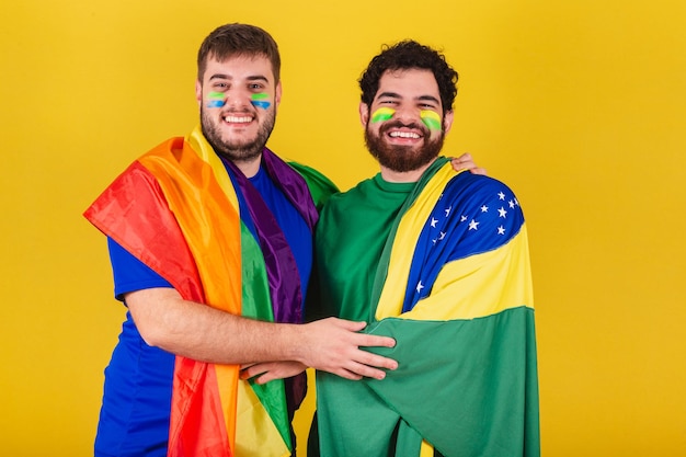 Couple of men brazilian soccer fans from brazil wearing lgbt