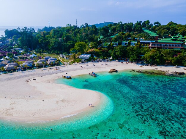 Couple of men and women on the beach of ko lipe island thailand