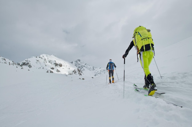 Couple of mountaineers with skis during a trip