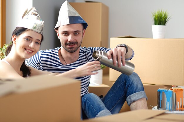 Couple moving in house sitting on the floor Couple