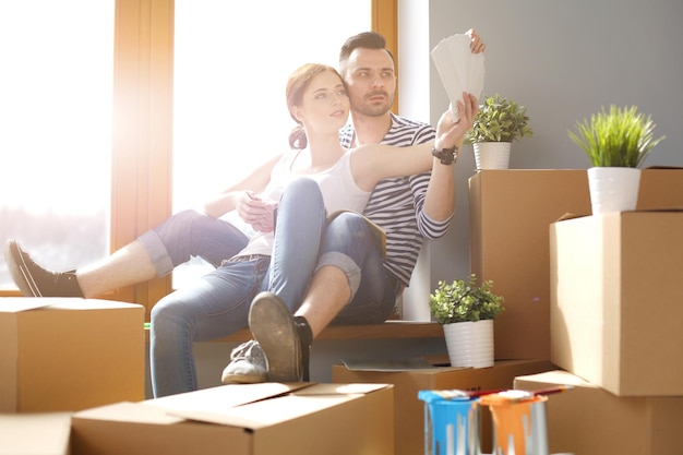 Couple moving in house sitting on the windowsill Couple