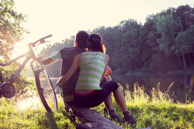 Couple near the river with bicycle