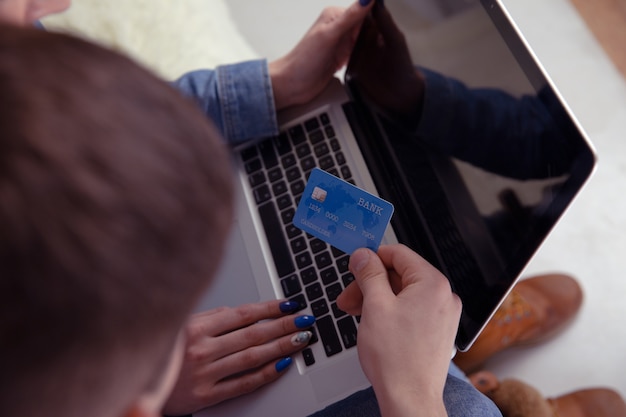 Couple online shopping concept. Credit card in the hand. Using computer.