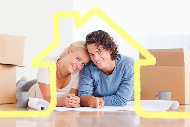 Couple organizing their future home against house outline