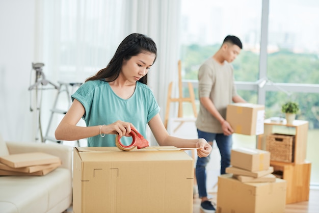 Couple packing the boxes to move