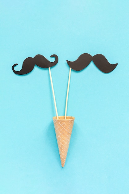 Couple paper mustache props in waffle cone Concept Homosexuality gay love. 