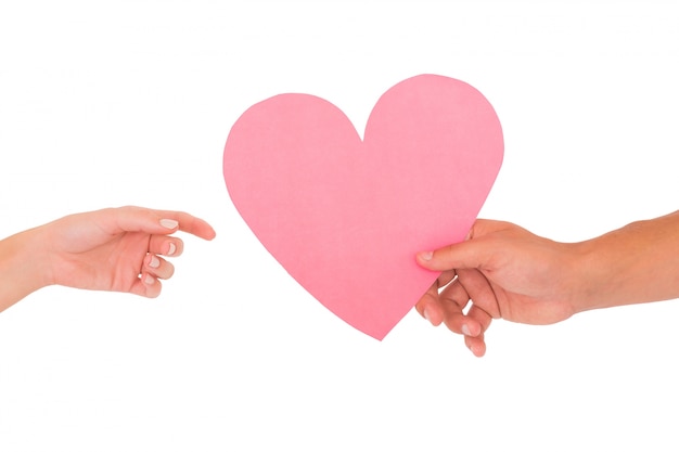 Couple passing a paper heart