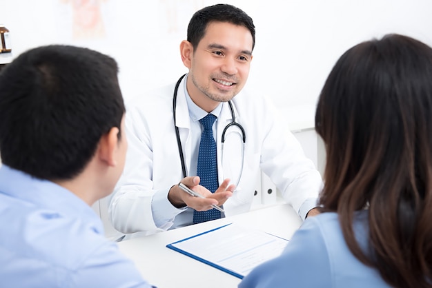 Couple of patients consulting with doctor