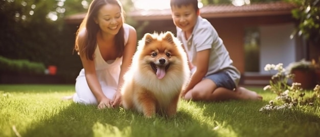 A couple of people sitting in the grass with a dog