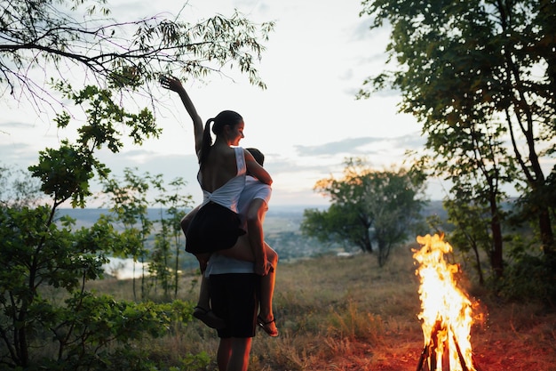 couple at a picnic with bonfire at nature