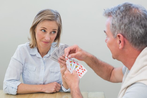 Couple playing cards at home