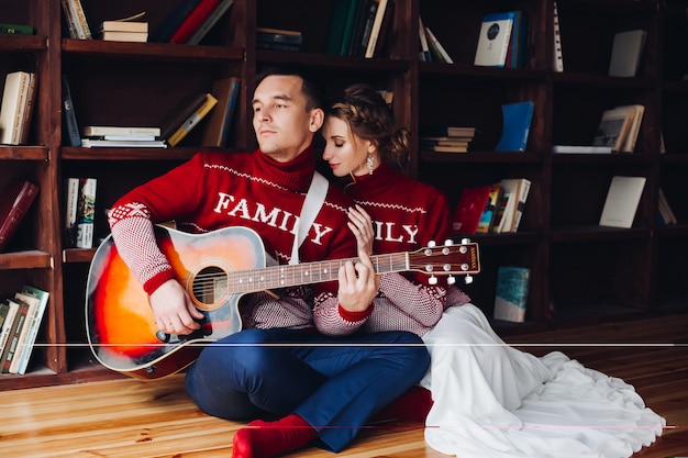 Couple playing on gitar and embracing