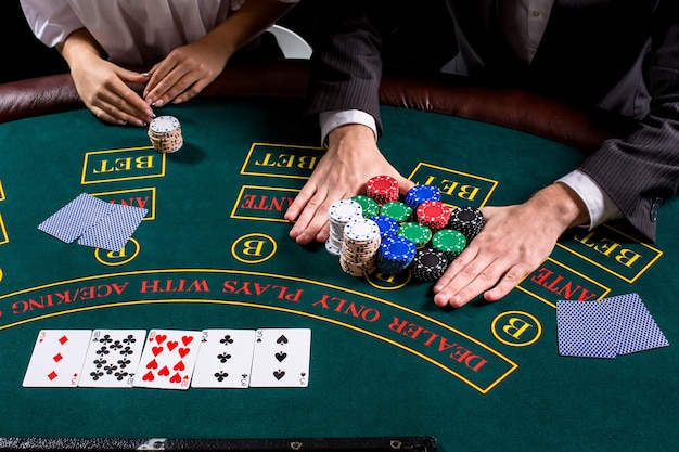 Couple playing poker at the table