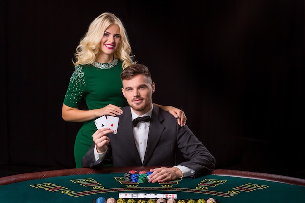 Couple playing poker at the table