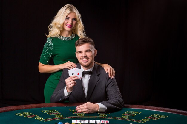 Couple playing poker at the table.