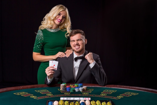 Couple playing poker at the table.