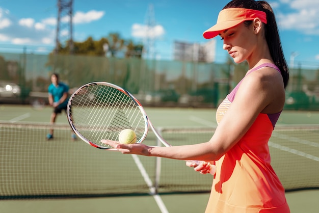 Пара, играющая в теннис на открытом корте