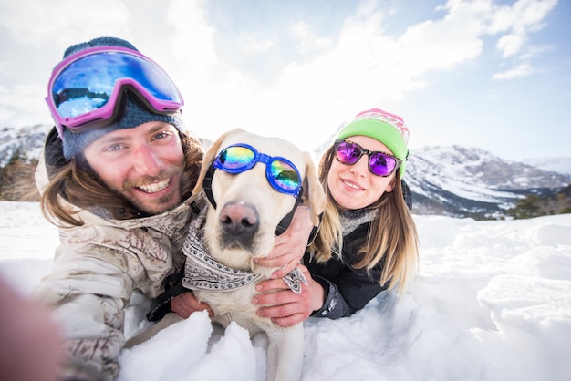 Couple playing with dog