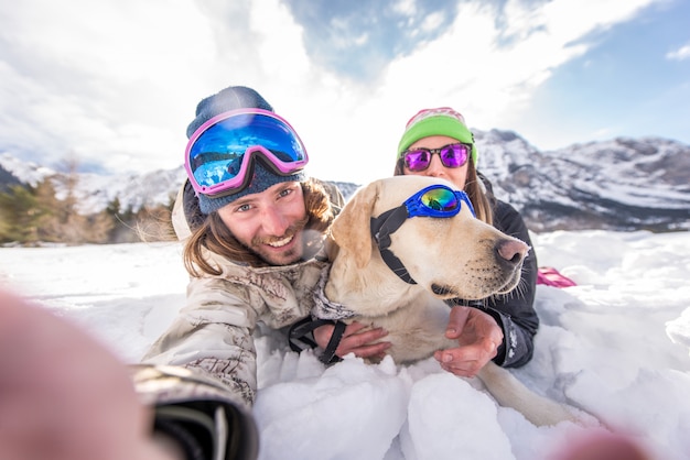 Couple playing with dog