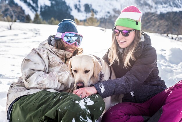 Couple playing with dog