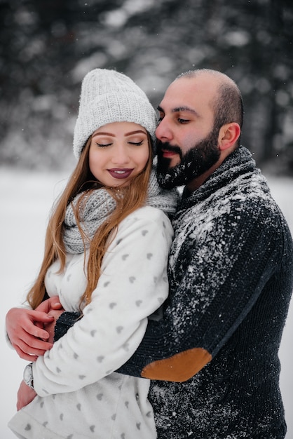 Couple playing with snow in the forest