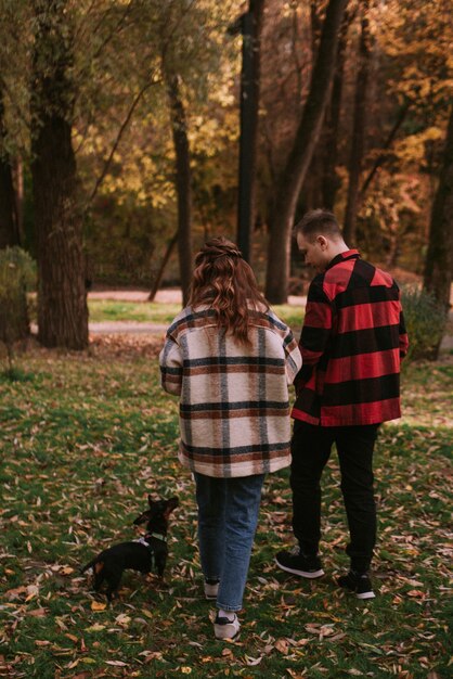 Couple playng with dog in the park