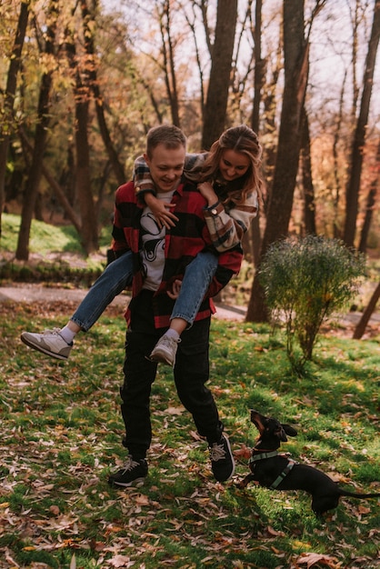 Couple playng with dog in the park