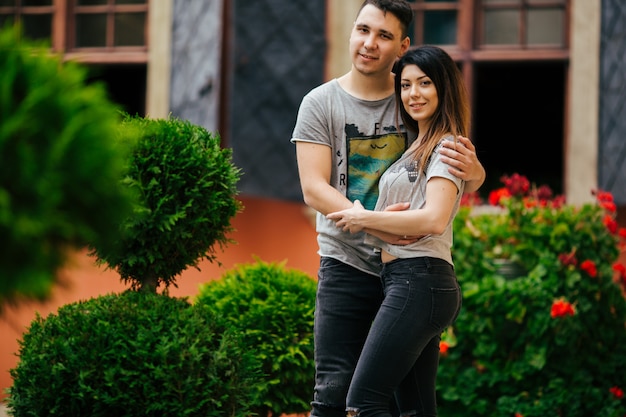 couple posing on the streets of a European city in summer weather.