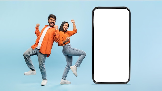 Couple posing with a blank smartphone screen