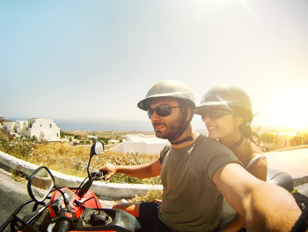 Couple on quad take a selfie santorini island