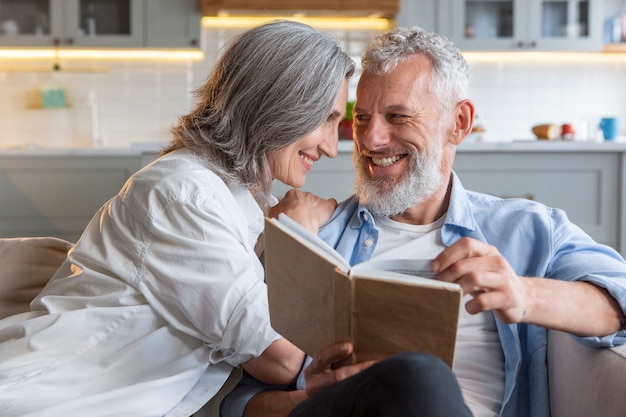 Couple reading together medium shot