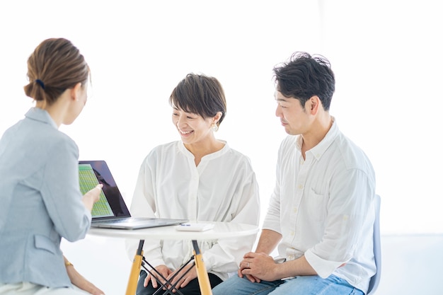 A couple receiving an explanation from a woman in a suit