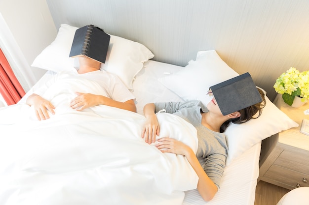 Couple reding book in bed