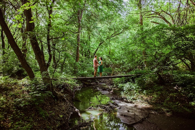 Couple relax in forest Green forest in summer